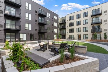 A modern apartment complex with a landscaped courtyard.